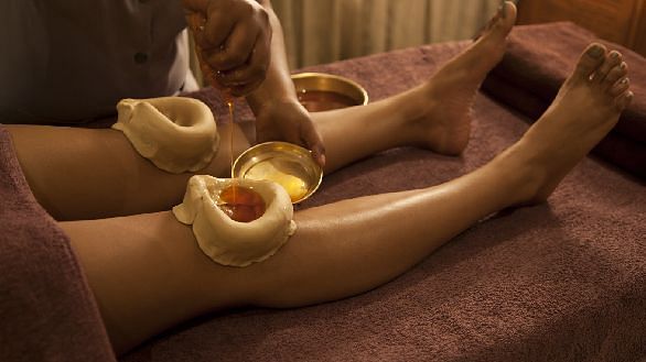 A relaxing leg massage using warm Ayurvedic oils - Shreyas Retreat