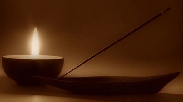 A close-up of a candle and incense, creating a peaceful spa ambiance - Shreyas Retreat