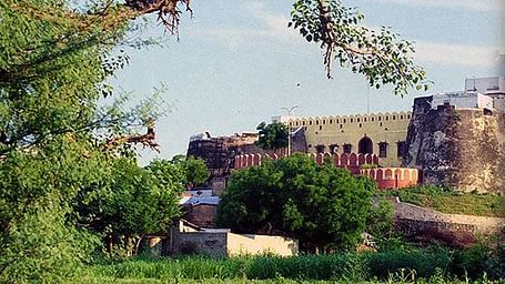 A collage image of the facade and rooms at Abhay Durg Dausa