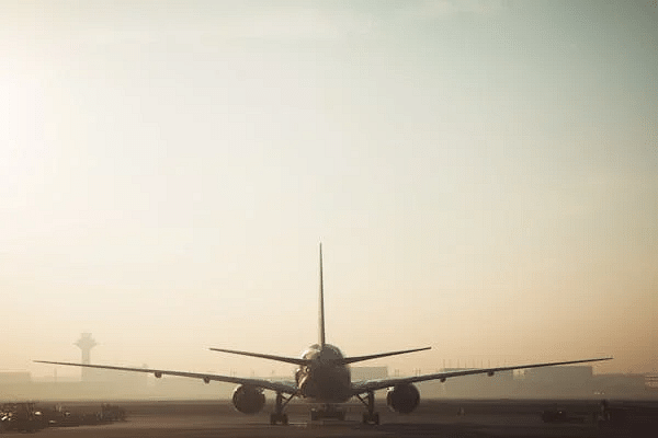 Aeroplane on a runway against a hazy sky.