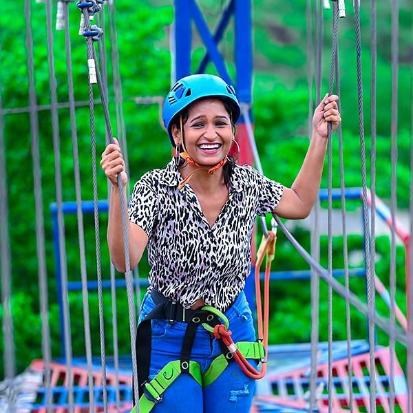 a girl posing for a picture while on an adventure ride - Diamond Parks, Pune 