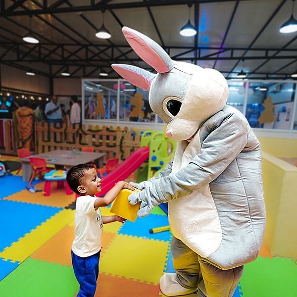 A child interacting with a person in a bunny costume - Diamond Parks, Pune 