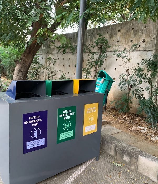 Outdoor waste segregation bin with separate compartments for wet, dry, and reject waste at Karma Chalets.