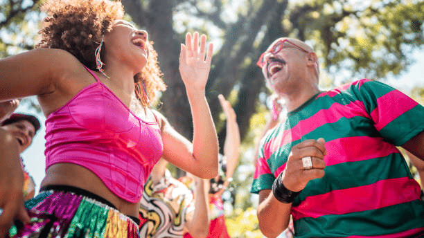 A view of People enjoying one of the New Year Events in Goa with a tree in the background.