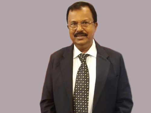 Finance Director Shivashankar in a gray background at UDS Group of Hotels