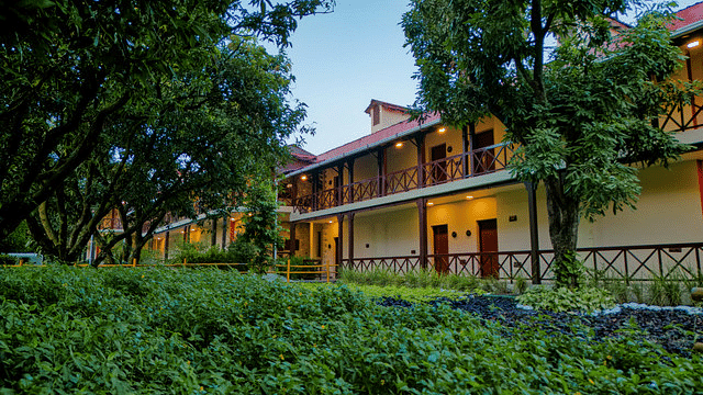 Resort building exterior with lush greenery and well-maintained landscaping.