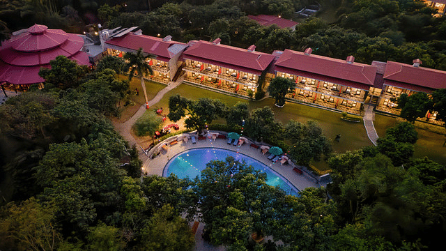 Aerial view of resort showcasing pool, gardens, and building layout.