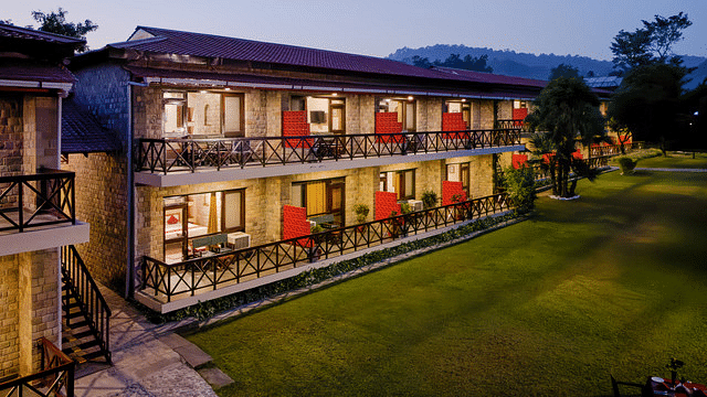 Illuminated resort building at night, creating a warm ambiance.
