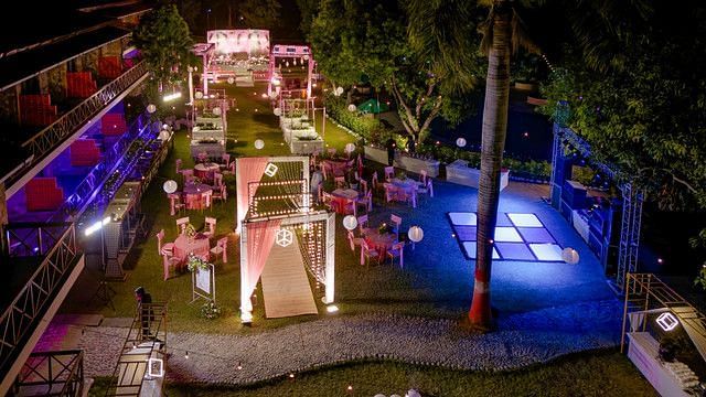 alt-text Aerial view of a wedding venue with a pool and lush landscaping.