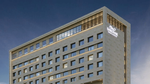 An exterior view of the Sarovar Premiere Alwar hotel building from a street perspective.