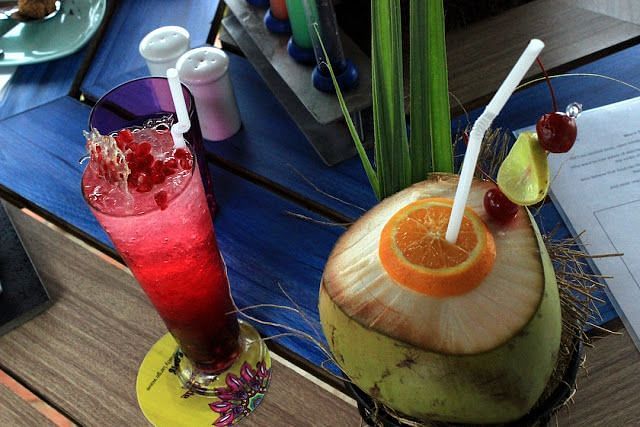An image of a mocktail served along side coconut water