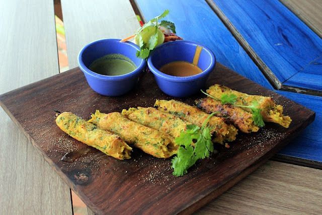 An image of a dish garnished with coriander served on a wooden platter