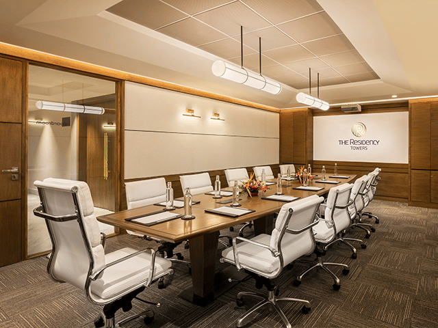 Board room at The Residency Towers Puducherry, featuring a long table with chair seating.