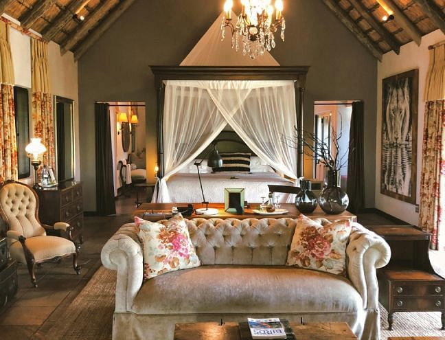 A hotel room with a double bed and sofa seating - Narrow Gauge Inn - A Serenite Hotel Near Fish Camp.