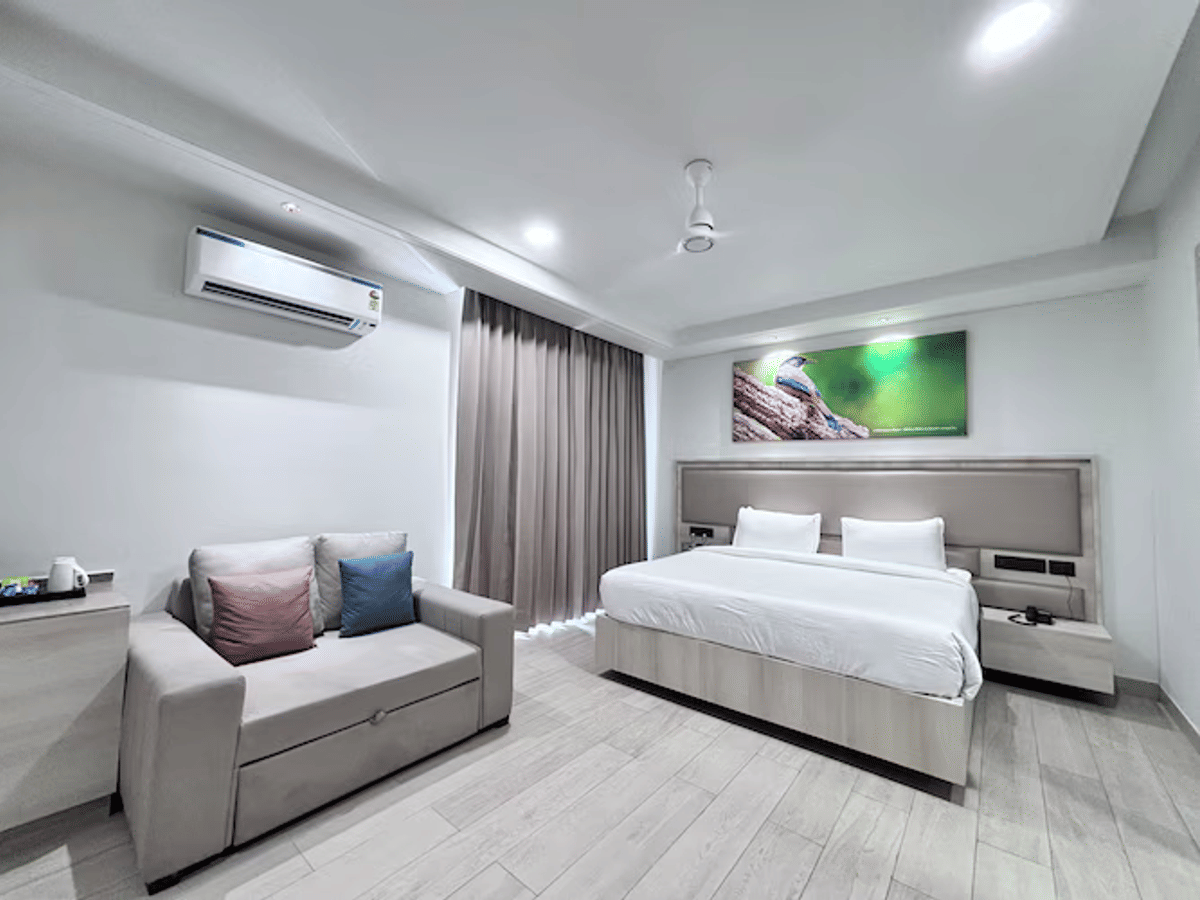 A Deluxe Double Room with lounge seating at Signum Tathastu Boutique Hotel, Haridwar