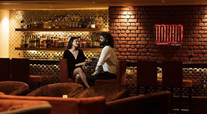 A man and a woman sitting at Dovka - Nirvana Luxury Hotel, Ludhiana.