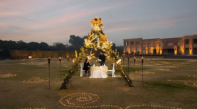 A romantic dining arrangement in the lawn area of Nirvana Luxury Hotel, Ludhiana during the evening