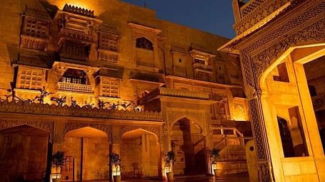 A warmly lit facade of Narayan Niwas Palace