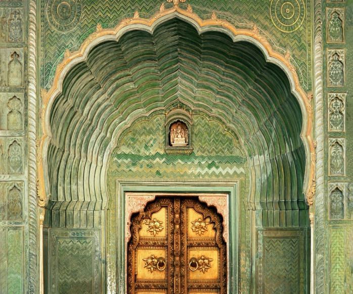 A entrance to a palace with vintage door painted in bright colours