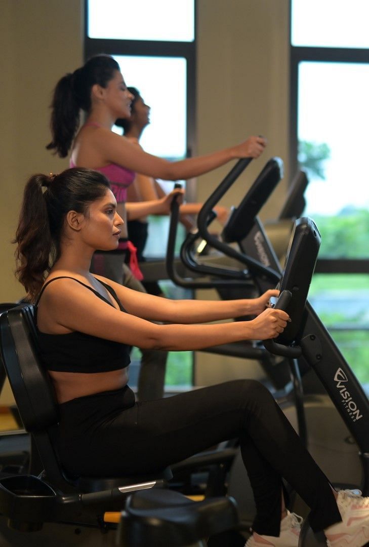 People exercising in the indoor gym at Singalila Club