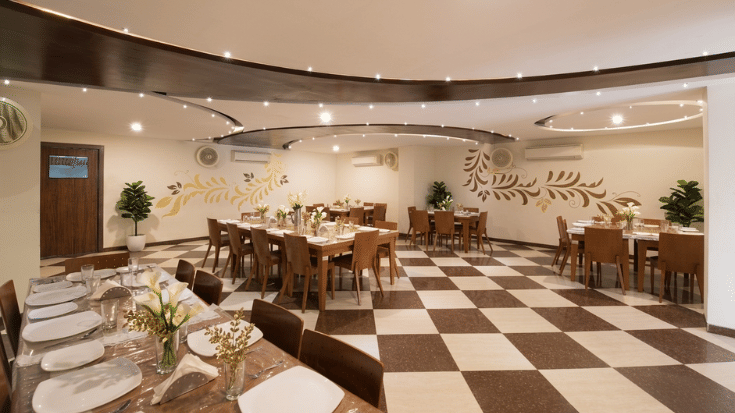 swaad dining space at vaikunth by Adamo with its radiant ambience and well furnished seatings.