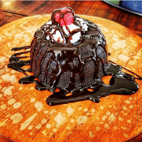 a dessert placed on a wooden plate at one of our restaurants 
