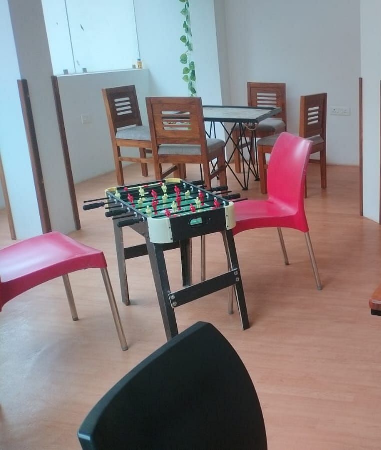 Indoor games room with chairs and a Connect Four game on the table at The Verda de Miranda Resort.