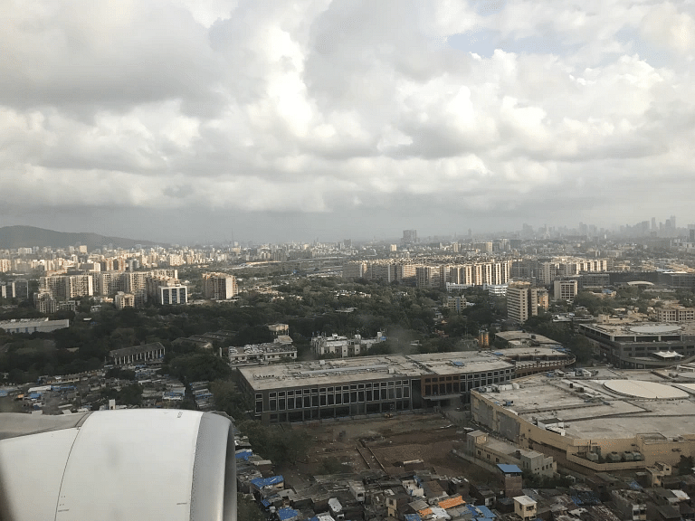 Overhead shot of the city with cloudy sky in the background.
