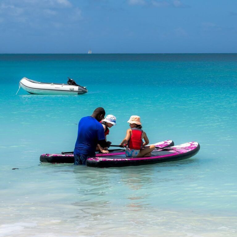 A family enjoying a kayak on the crystal-clear turquoise waters of the sea - Tamarind Hills Resort and Villas - Antigua
