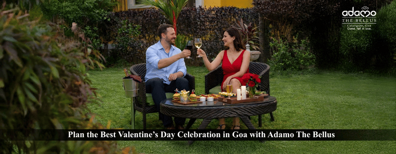 A couple in the outdoor garden seating of the hotel enjoying drinks.