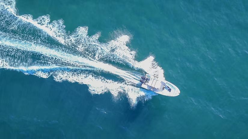 A speedboat cutting through the waves of the ocean.