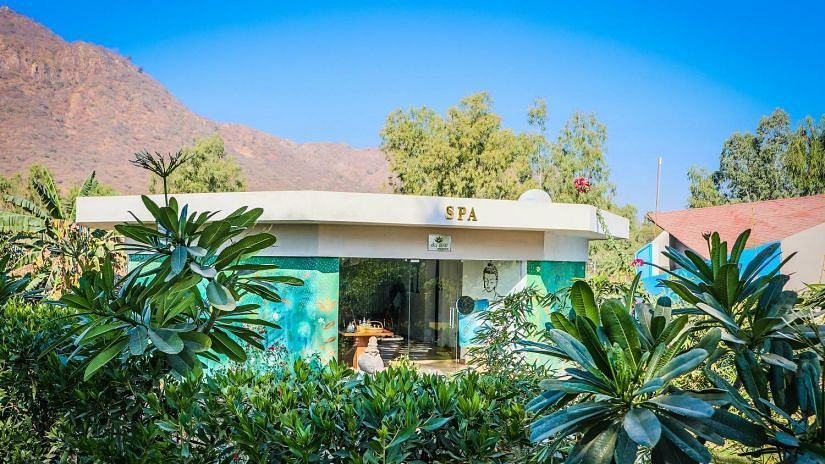 A building with SPA signage, surrounded by lush greenery.