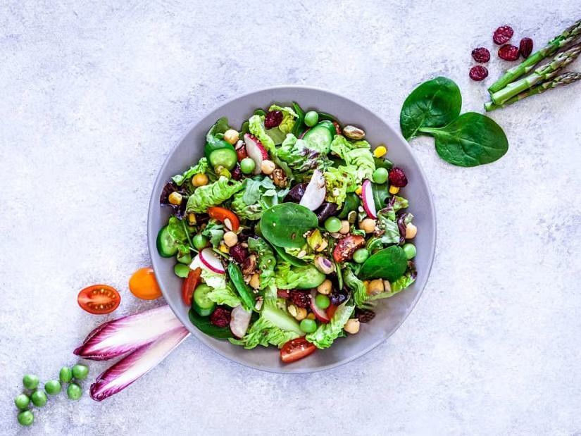 A colorful salad with various fresh vegetables, symbolizing a healthy and balanced diet.