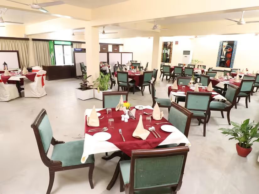 Lighthouse Restaurant features square tables set with cutlery, with chairs arranged on all four sides for guests.