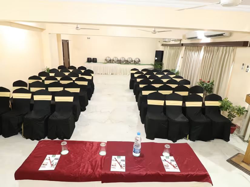 Pelican Event Hall features a large conference table at the front, with seating sections arranged on both the left and right sides