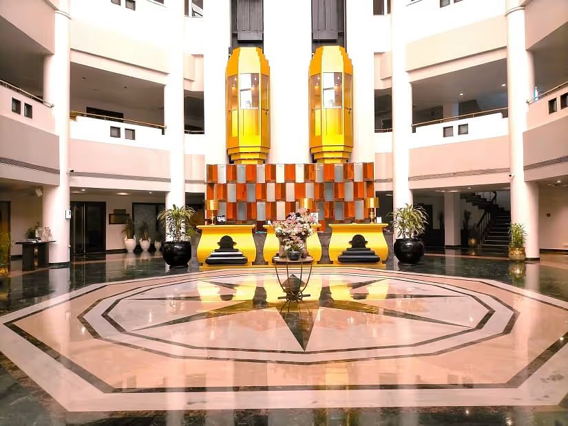 Lobby area of Swosti Resorts with polished floors and high ceilings