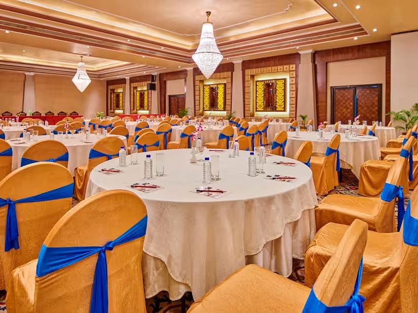 Event area with tables and chairs, and the hall decorated for a celebration.