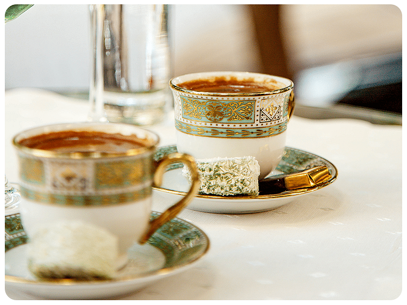 Close-up of tea cups with saucers on a table.