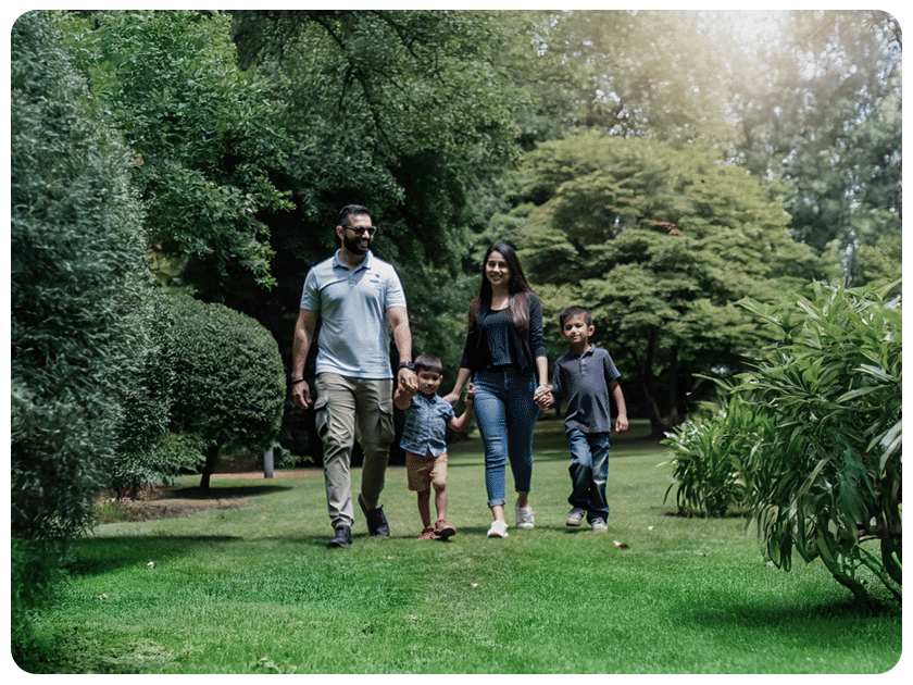 Family walking together in a lush green garden at Ramoji Film City.
