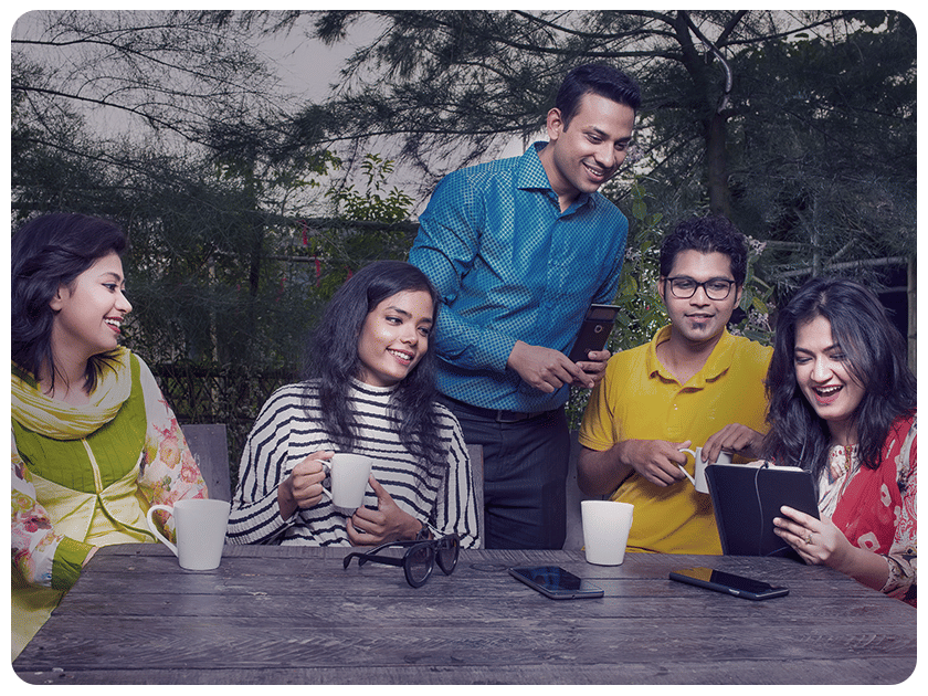 Group of friends enjoying drinks and conversations outdoors at Ramoji Film City.