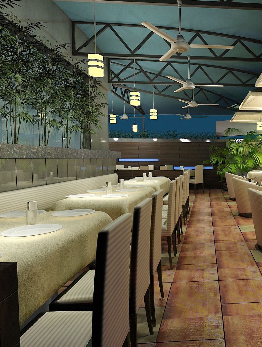 Outdoor dining area with chairs and tables arranged neatly, surrounded by plants at Oriental Aster, Mumbai.