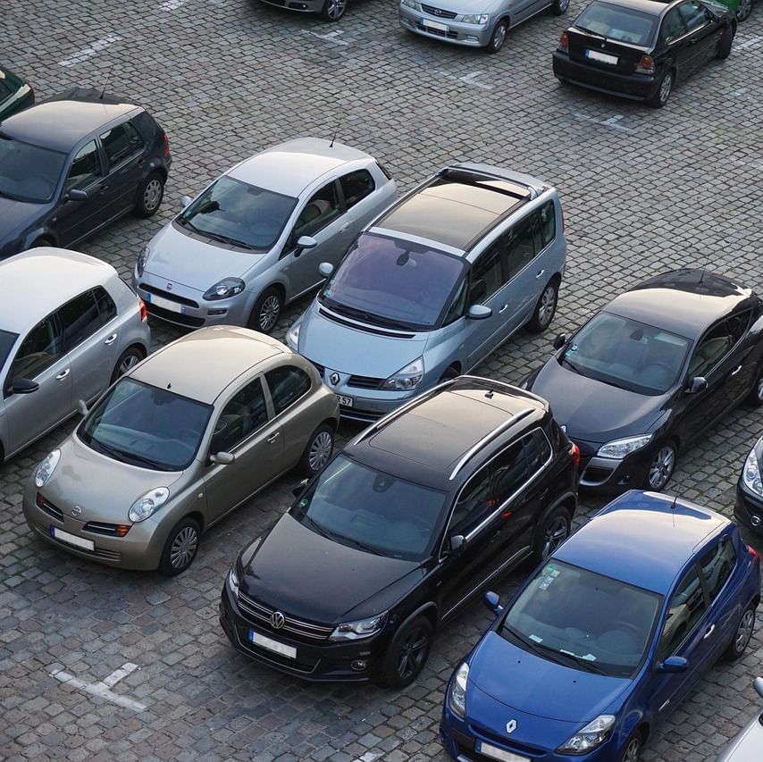 Cars parked closely together in a parking lot.