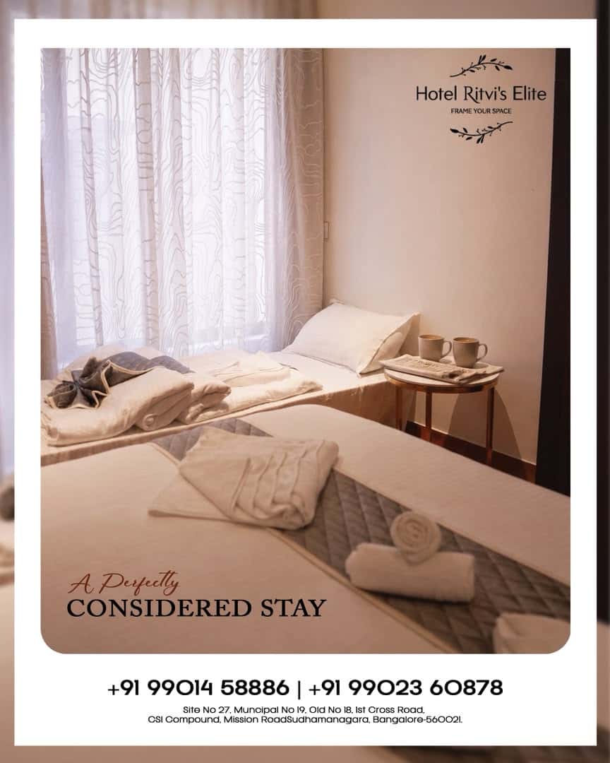 Guest room at Hotel Ritvi's Elite with two beds beside a curtained window
