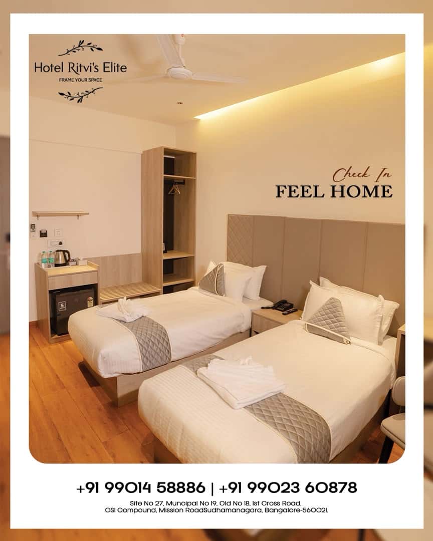 Guest room at Hotel Ritvi's Elite with two beds beneath cove lighting