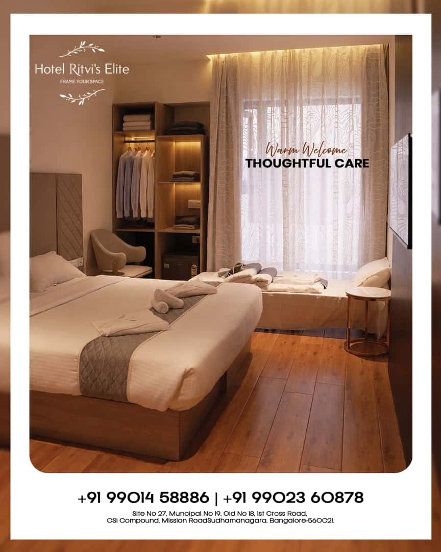 Guest room at Hotel Ritvi's Elite with two beds and an open wardrobe