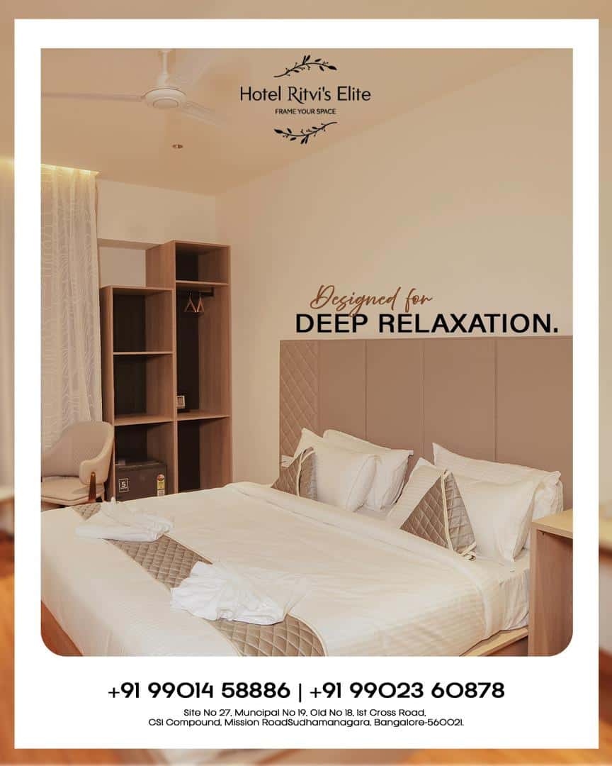 Guest room at Hotel Ritvi's Elite with a wide bed and open wardrobe shelving