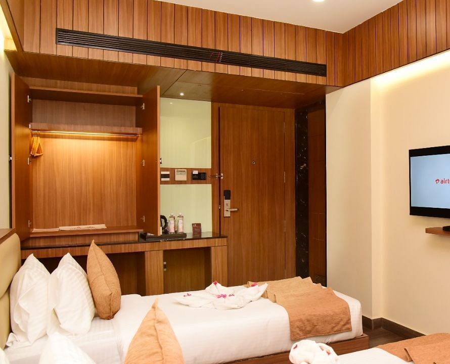 Twin beds with an LCD Television at TGI Felicity, Bangalore