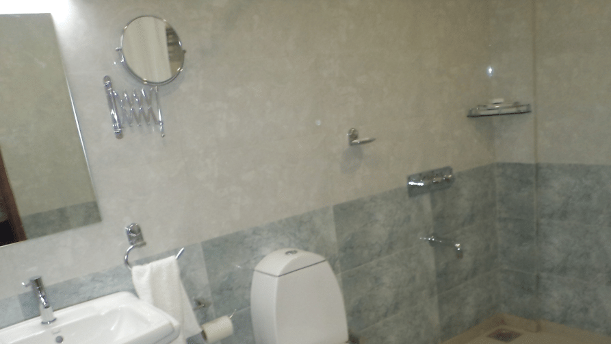 Modern bathroom with toilet, sink, and shower area