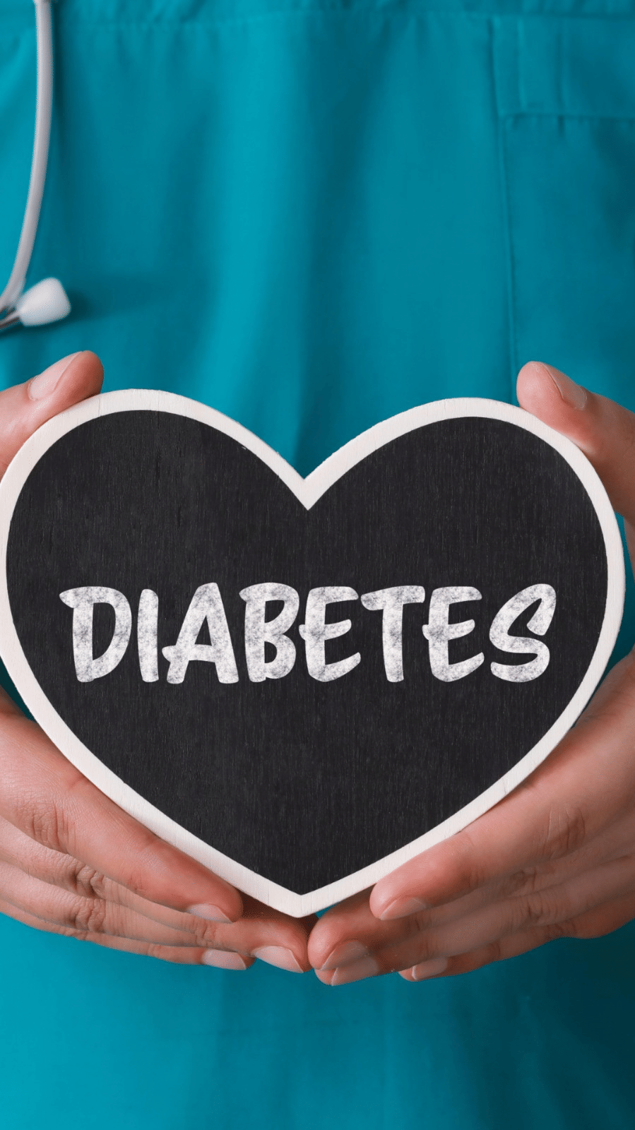 A person with a stethoscope holds a heart shaped object saying DIABETES