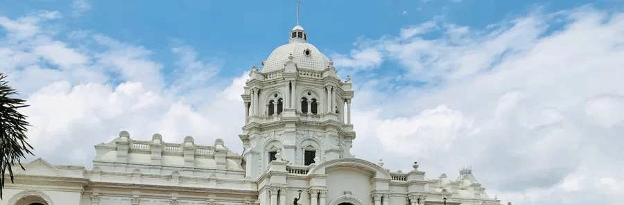 A wide shot of two-story white Ujjayanta Palace in Agartala.